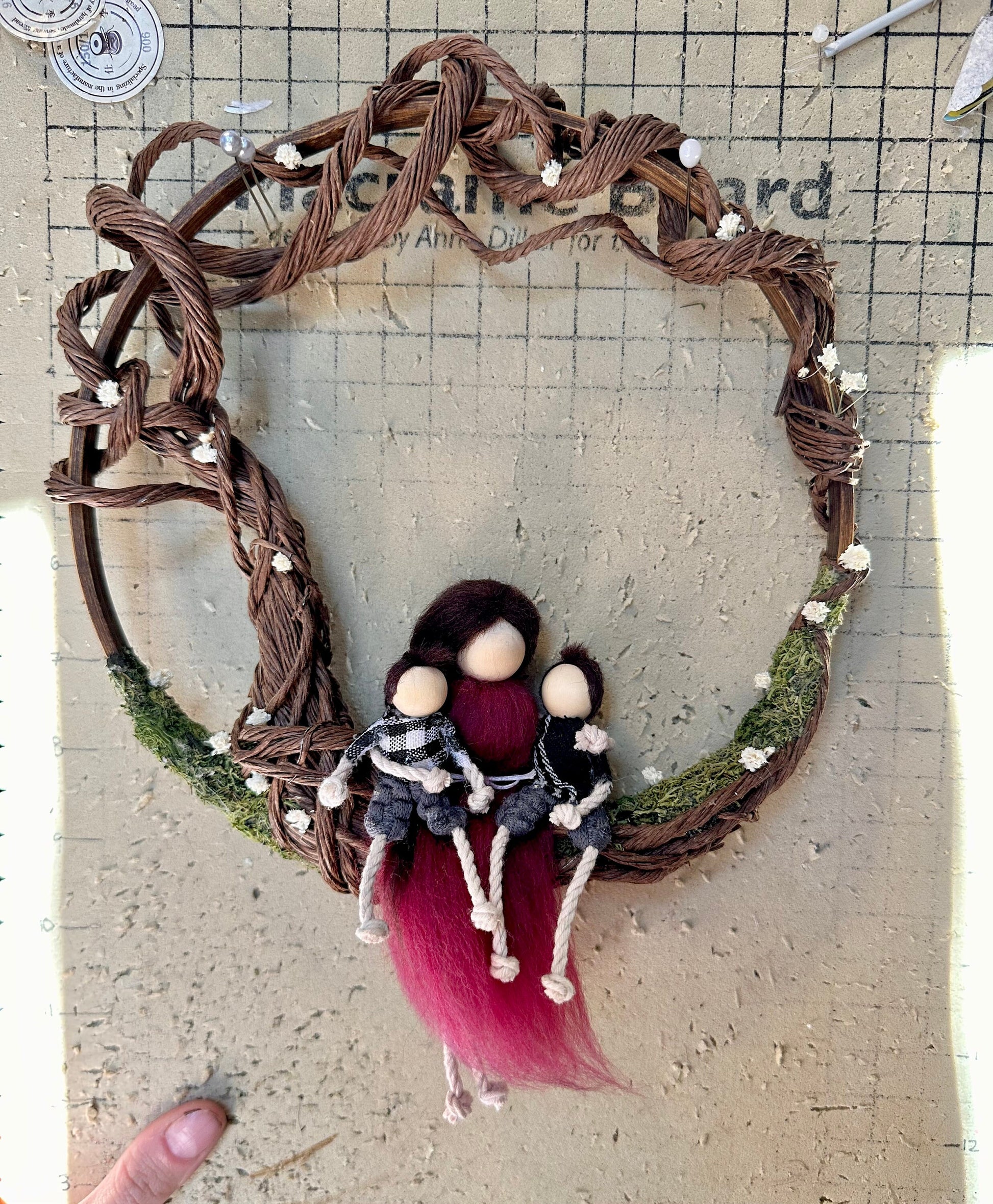 Tree of life family portrait made with handmade dolls, on a wooden ring.