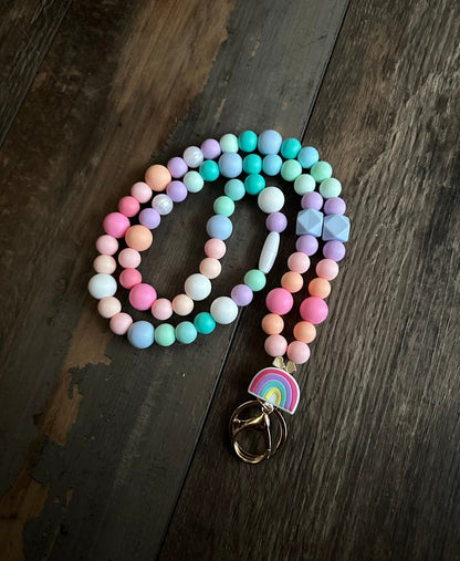 Rainbow lanyard for teachers nurses with silicone beads and a gold clasp pastel rainbow pattern with breakaway clasp closure. This lanyard come with specialty beads all in a soft silicone! Easy to clean and strong lanyard. Teachers gift!