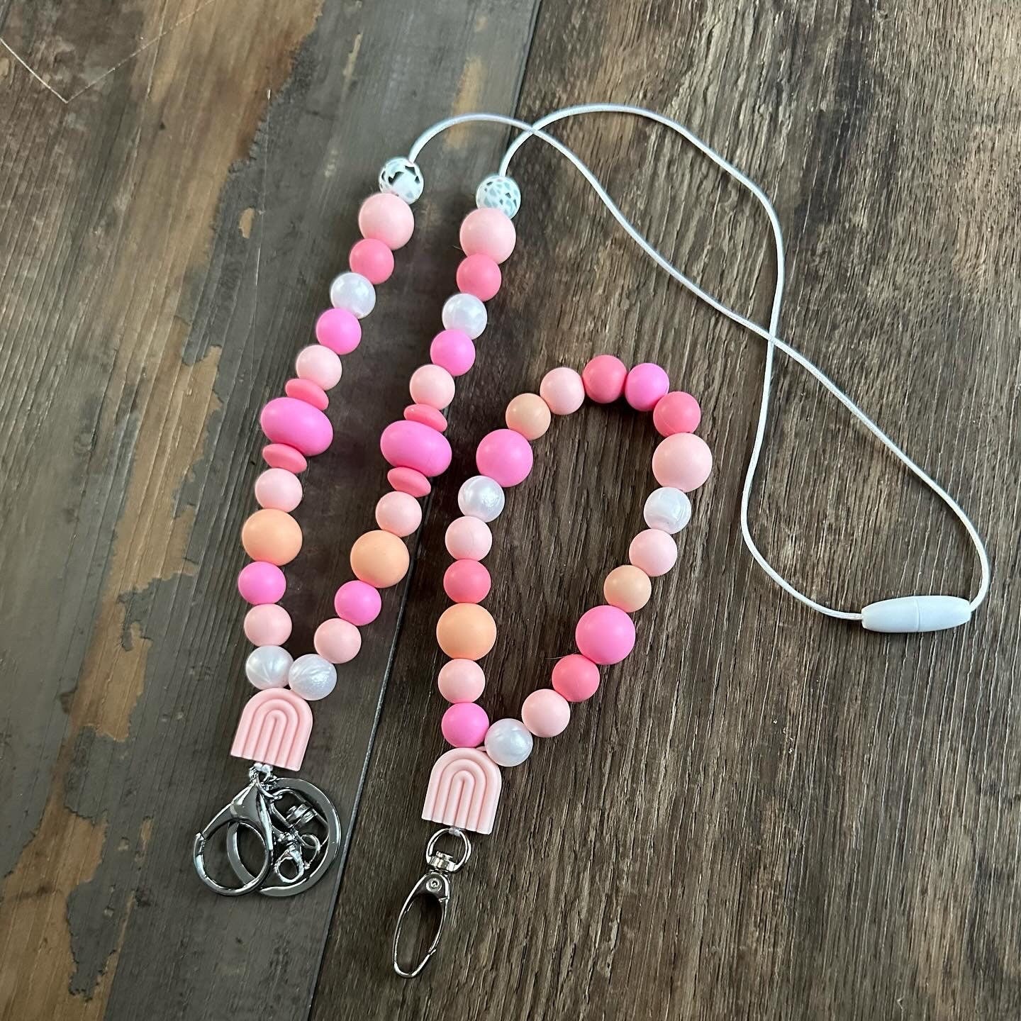 Cute pink silicone bead lanyard with soft, quality silicone beads adorable focal bead and clasp options id badge lanyard with break away clasp for teachers nurses and professionals adult pink and iridescent pearl silicone beads. Silk cord for comfort