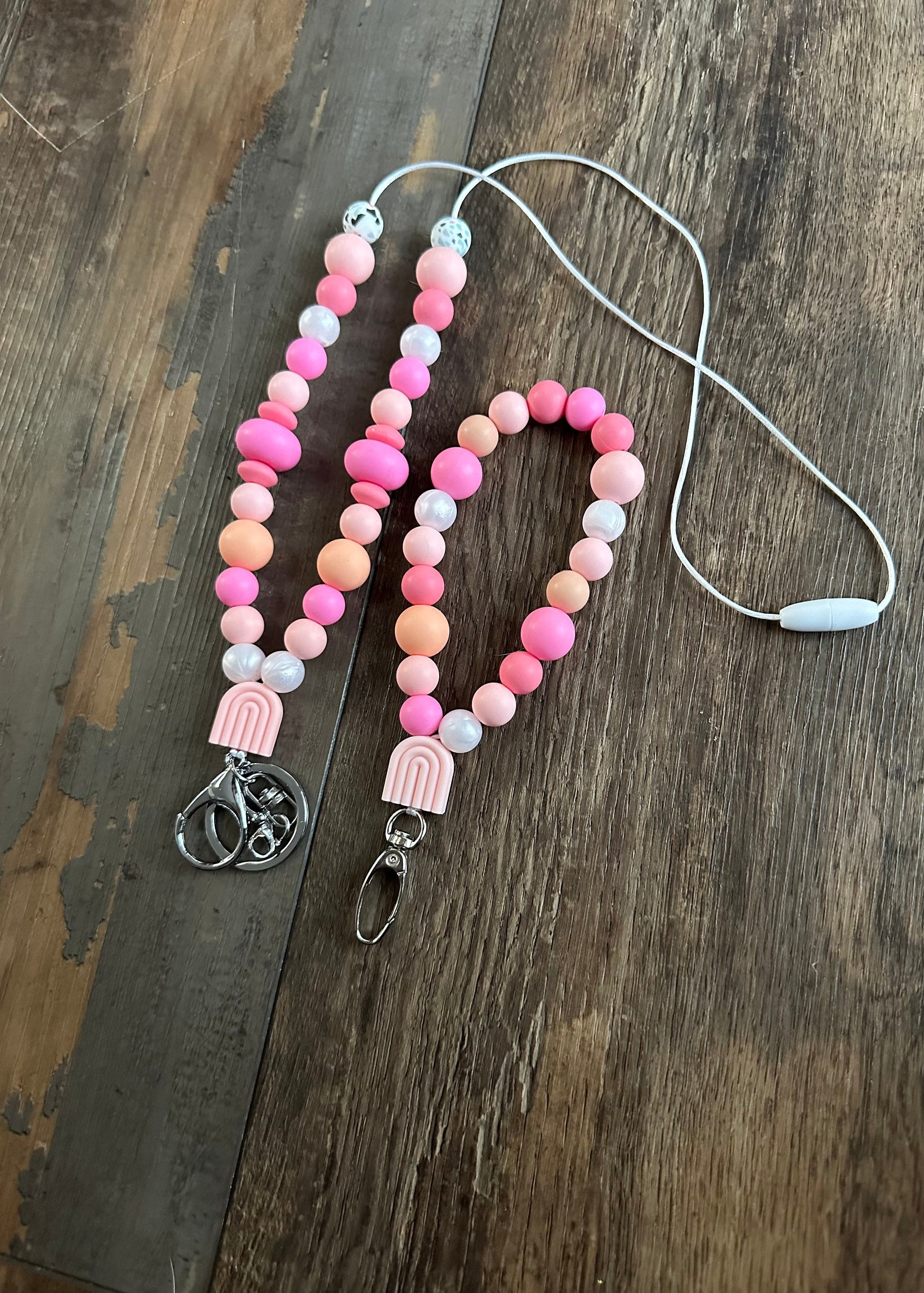 Cute pink silicone bead lanyard with soft, quality silicone beads adorable focal bead and clasp options id badge lanyard with break away clasp for teachers nurses and professionals adult pink and iridescent pearl silicone beads. Silk cord for comfort