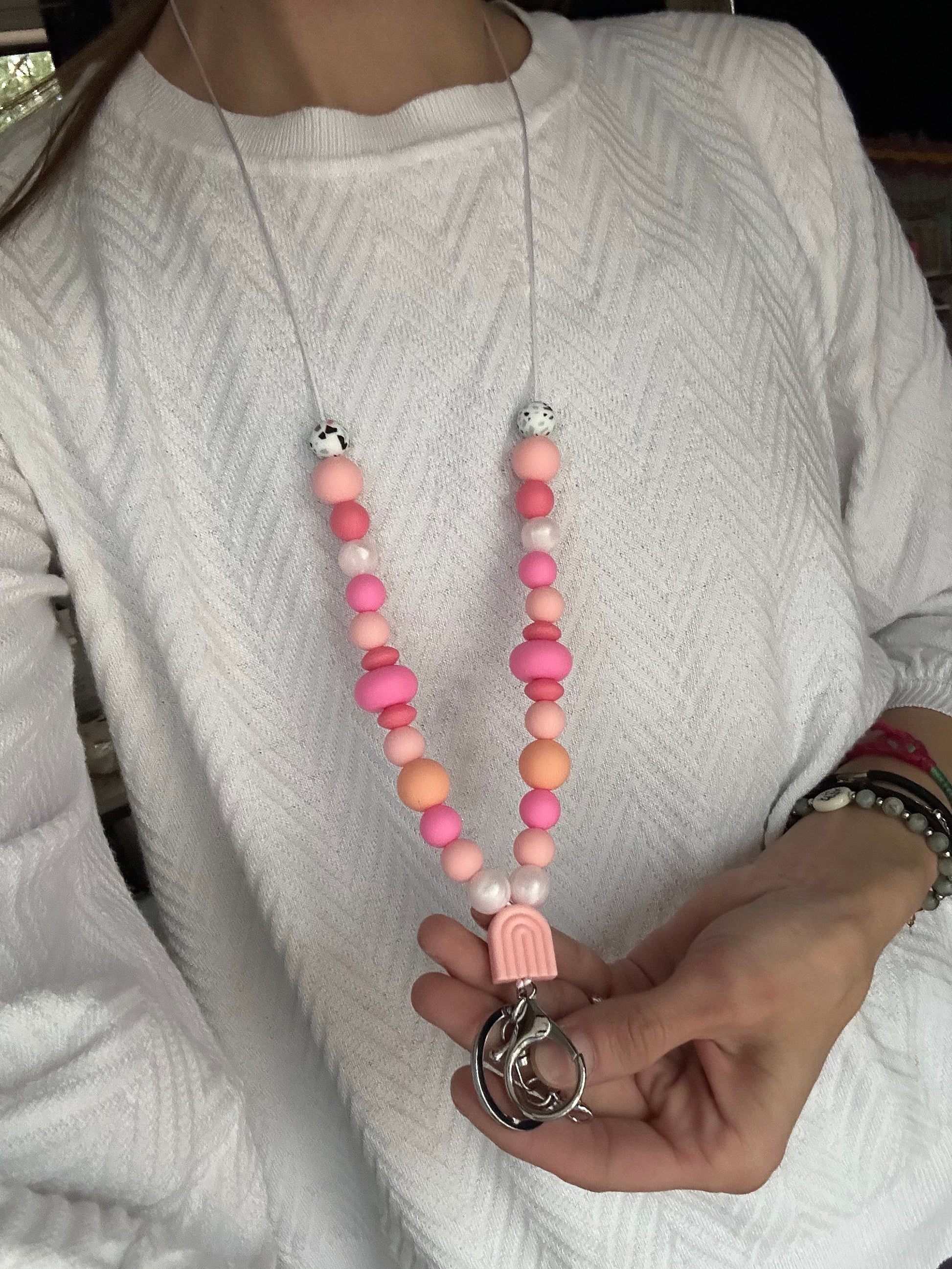 Cute pink silicone bead lanyard with soft, quality silicone beads adorable focal bead and clasp options id badge lanyard with break away clasp for teachers nurses and professionals adult pink and iridescent pearl silicone beads. Silk cord for comfort