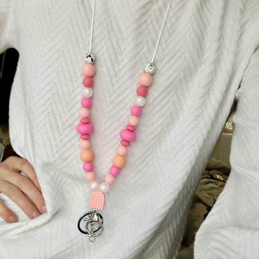 Cute pink silicone bead lanyard with soft, quality silicone beads adorable focal bead and clasp options id badge lanyard with break away clasp for teachers nurses and professionals adult pink and iridescent pearl silicone beads. Silk cord for comfort