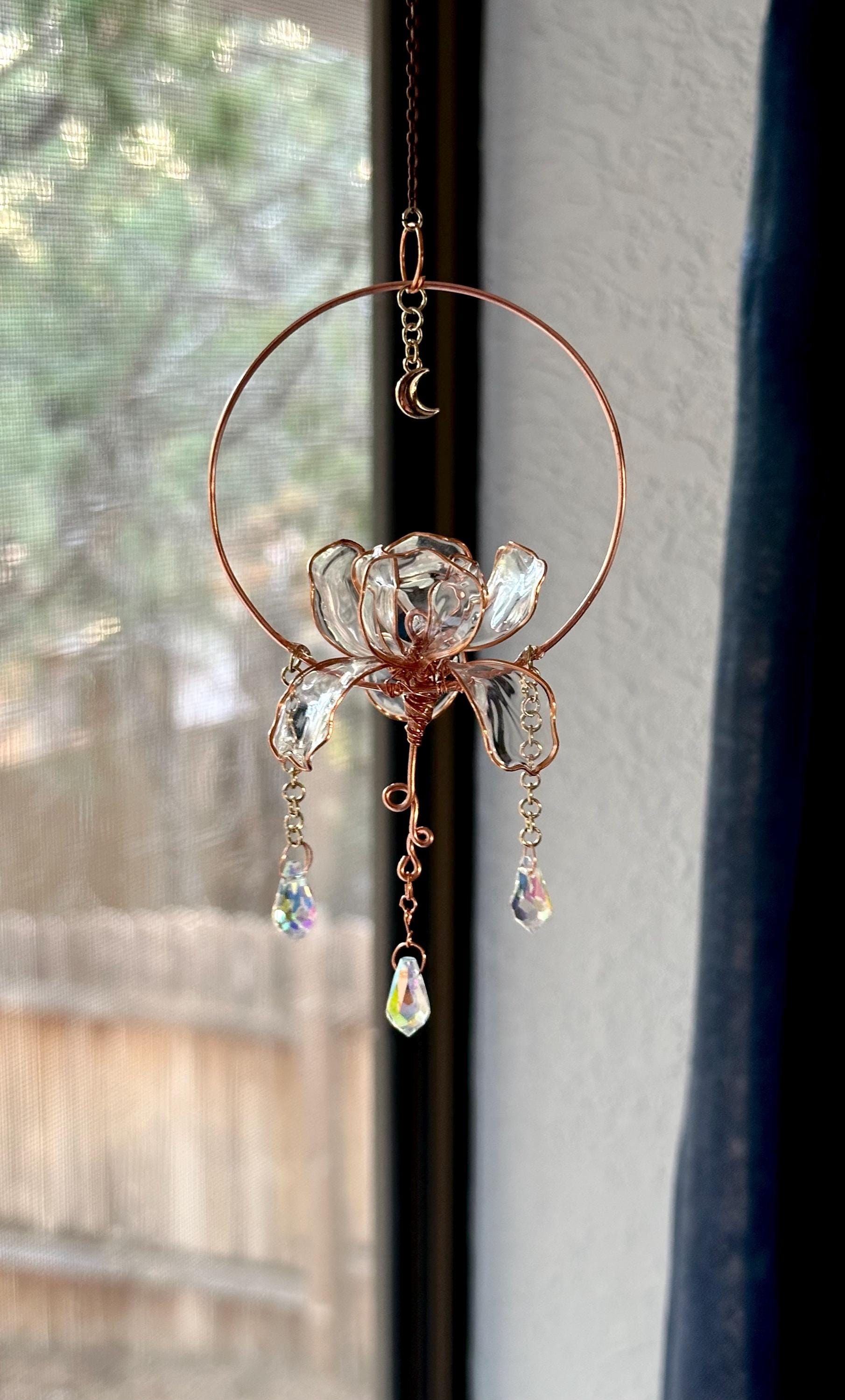 This is my handmade Copper wire and UV epoxy Iris flower settled into a copper ring, with dangling prisms and a moon charm.